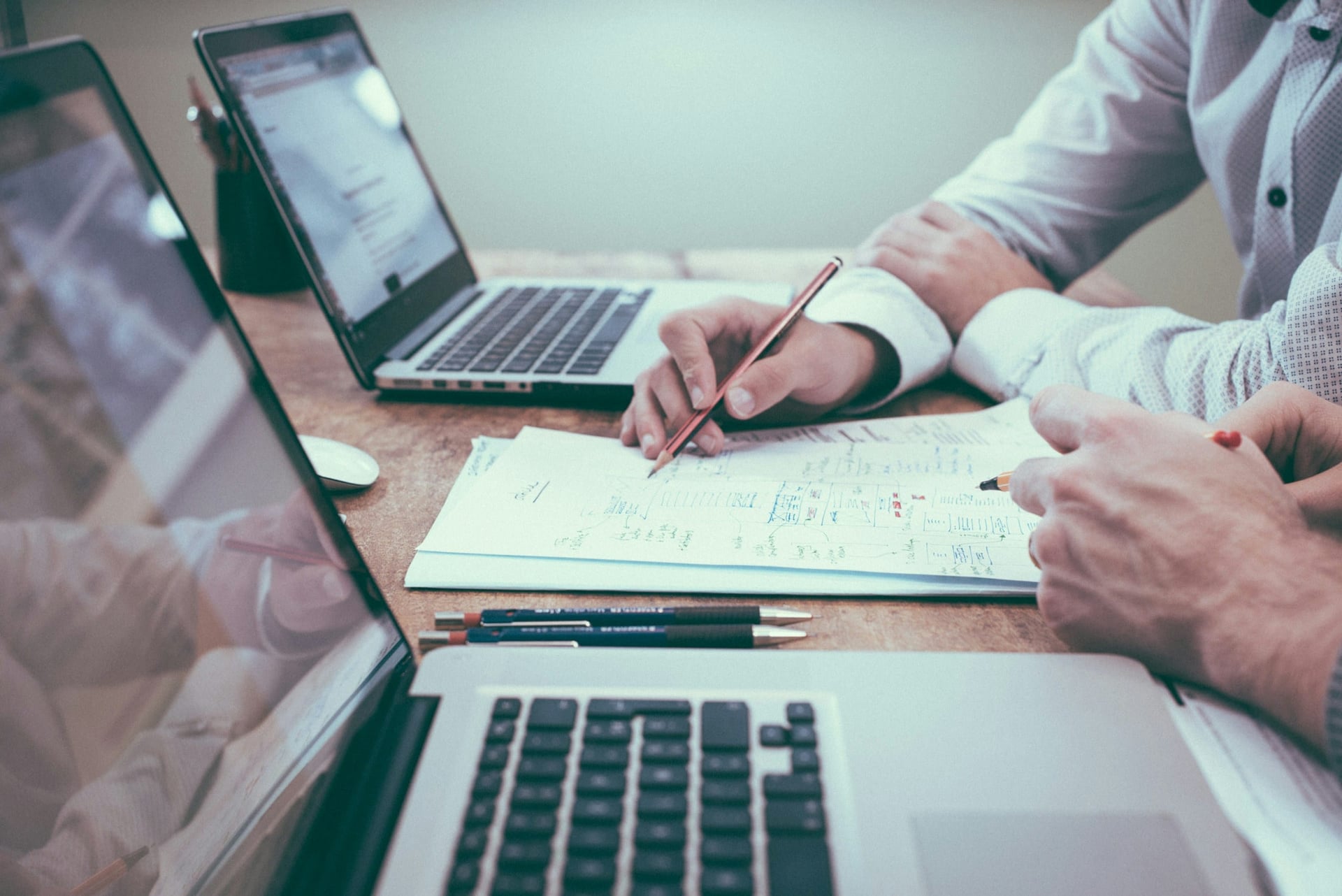 Laptops and project documents on a meeting table