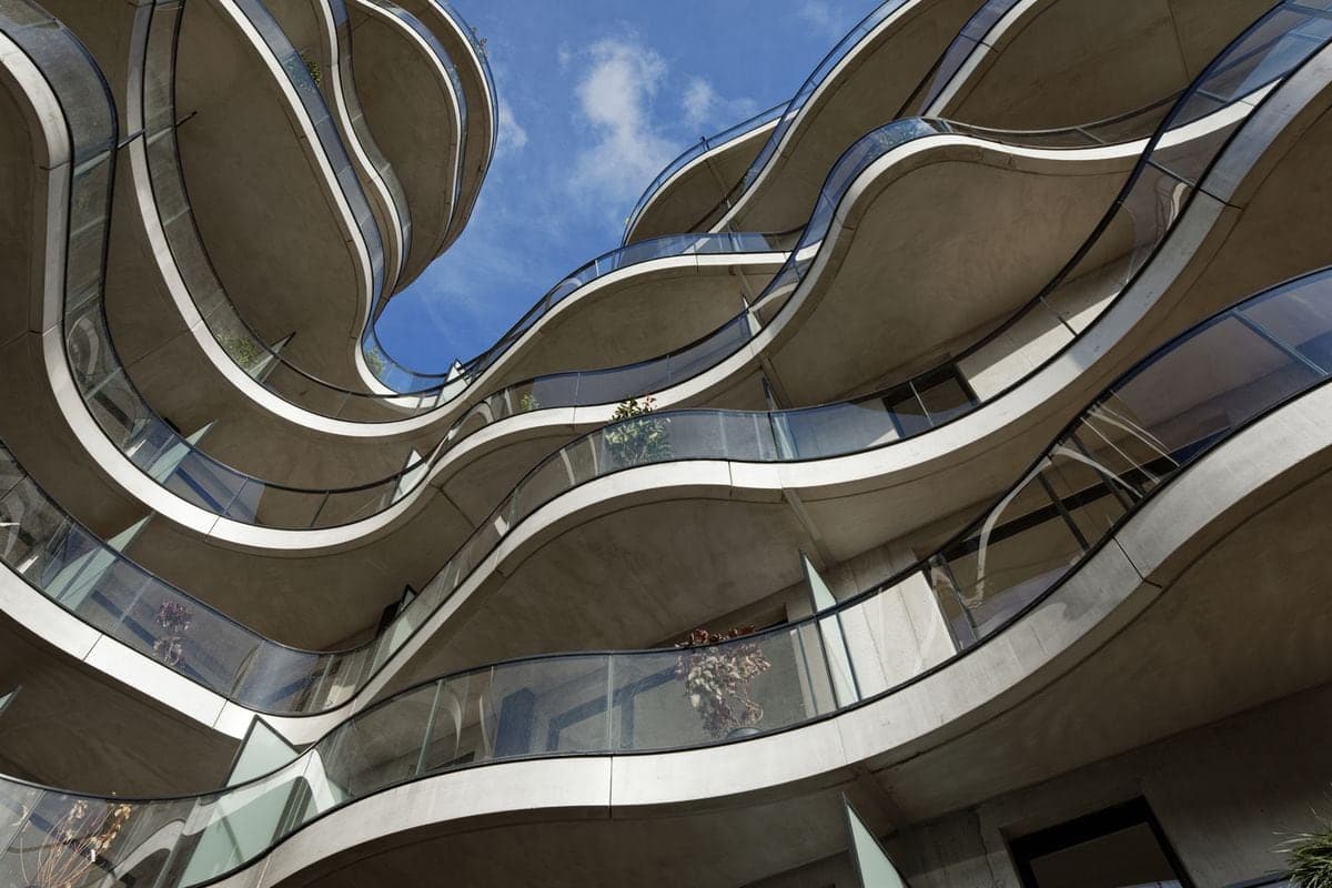 Curving white balconies seen from below