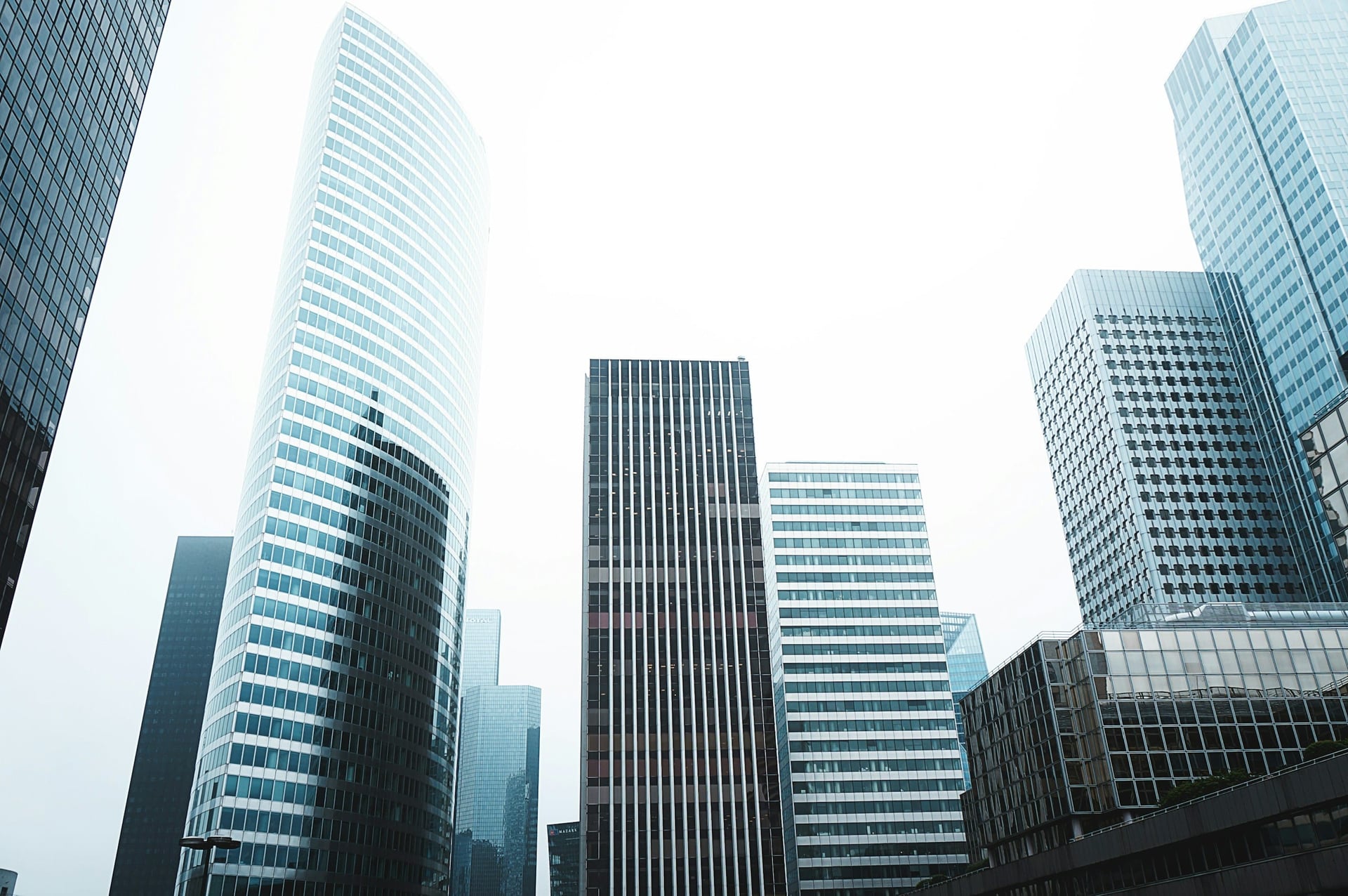 Glass towers seen from below against the sky